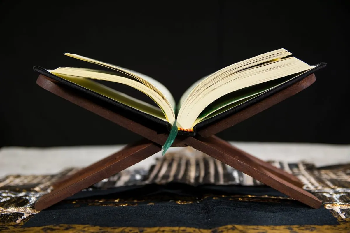 An open Quran on a wooden stand